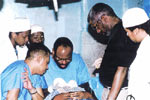 Dr. William Hurd and Dr. Lawrence Madlock performing an operation.