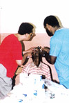 Dr. Bernetta Davis Poole and Dr. William Hurd performing an exam.